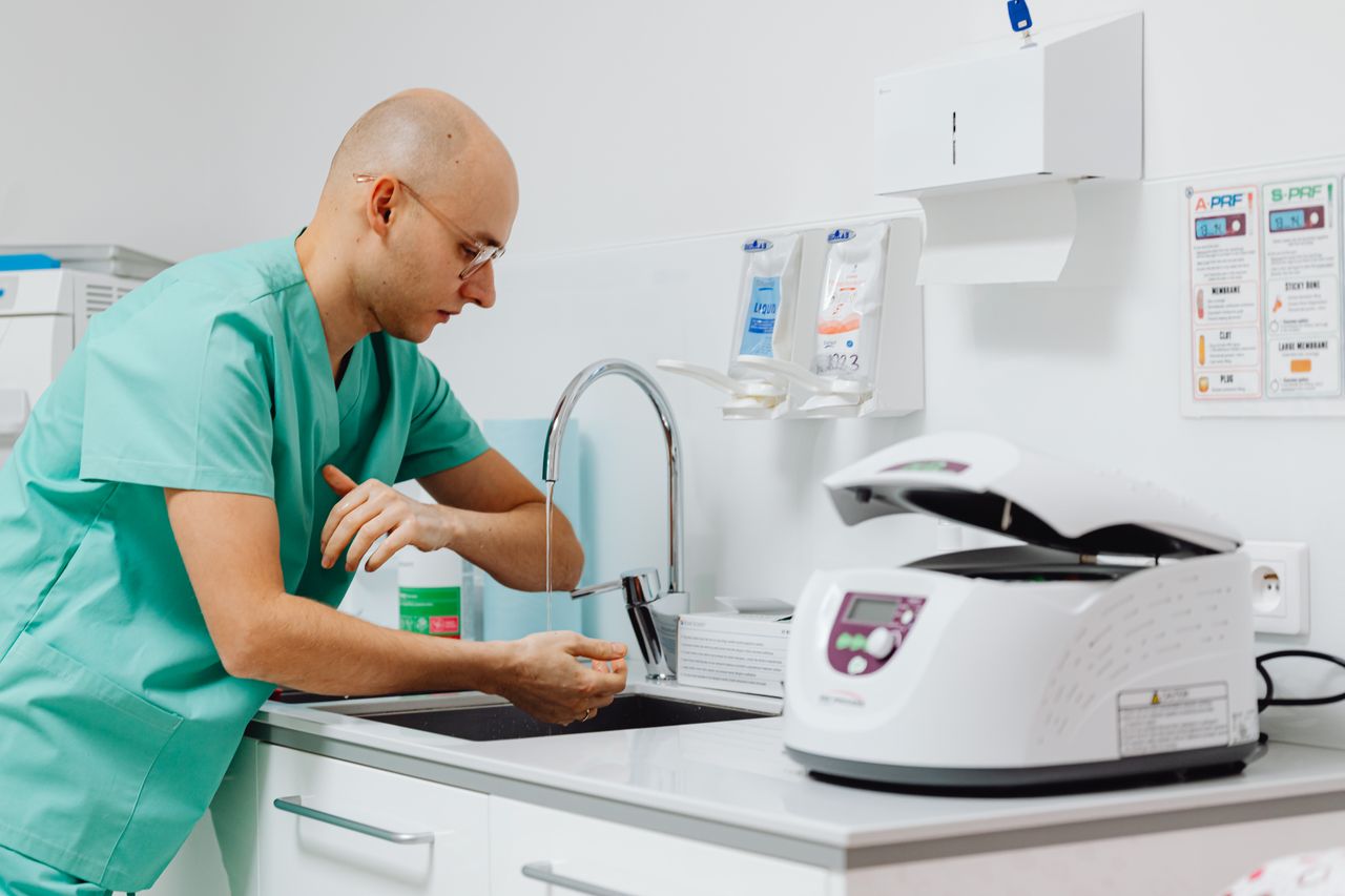 A medical professional practicing hand hygiene in a clinical setting.